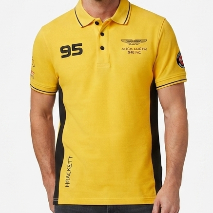 A man modeling a yellow and black short-sleeve polo shirt with '95' printed on the chest, paired with dark gray jeans and white sneakers, against a light gray studio background.
