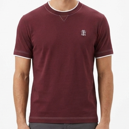 Man wearing a maroon t-shirt and gray pants on a white background