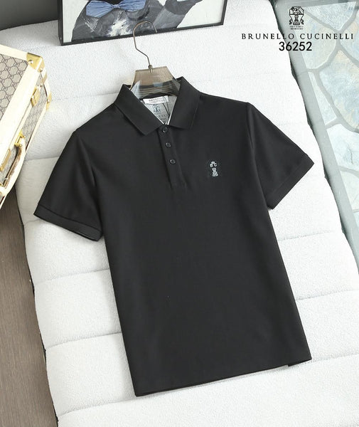 Black polo shirt with a brand logo on a white surface