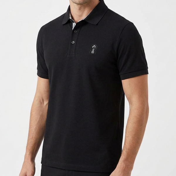 Man wearing a black polo shirt with a small logo on a white background